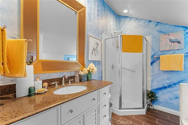 a view of a patio with table and chairs with plants and wooden fence