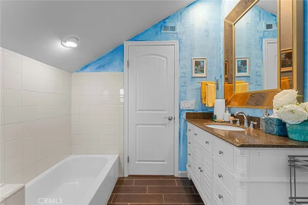 a patio with table and chairs with potted plants