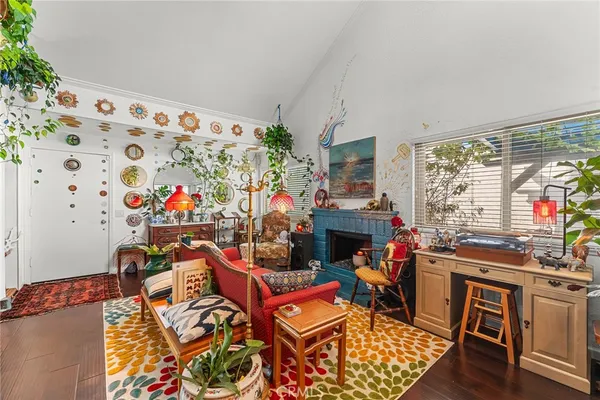 a living room with furniture a fireplace and a flat screen tv