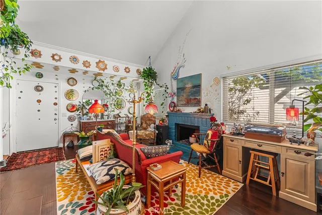 a living room with furniture a fireplace and a flat screen tv