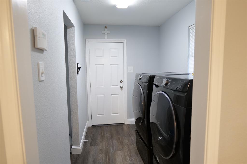 7137 Hunnicut Road Dallas, TX 75227 - Photo 12 of 16 Dedicated laundry area featuring wood-finish flooring and light-toned walls