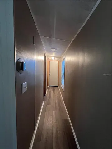 a view of hallway with wooden floor