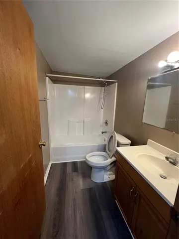 a bathroom with a sink a toilet and a shower