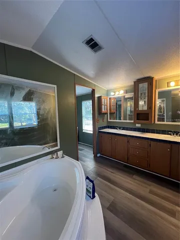 a bathroom with a double vanity sink and mirror