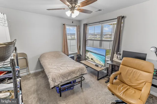 a bedroom with furniture and a window