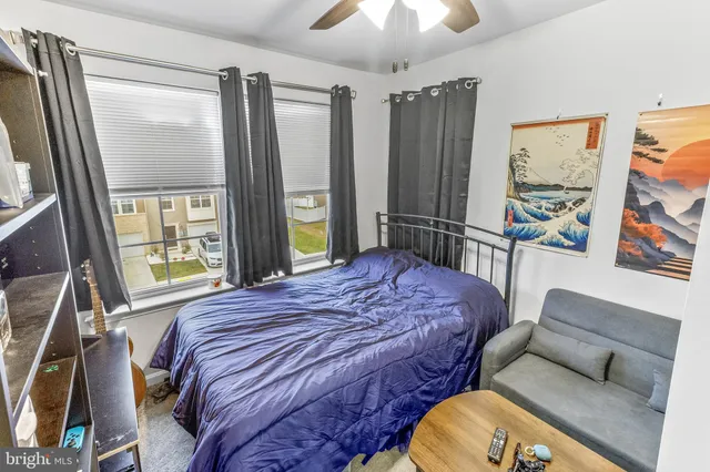 a bedroom with a bed wooden floor and window