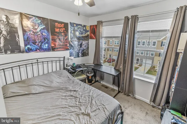 a bedroom with a bed and a painting on the wall