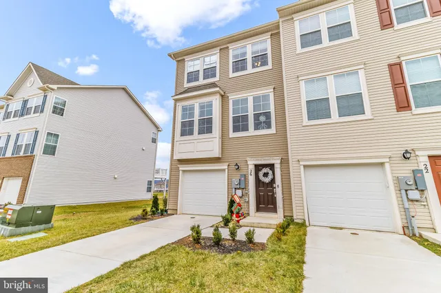 a view of a house with swimming pool and sitting area