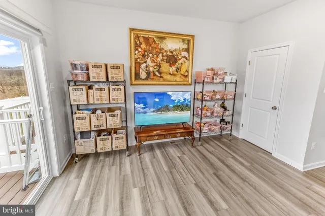 an empty room with large window and furniture