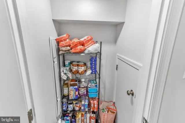 a utility room with lots of clutter and washer
