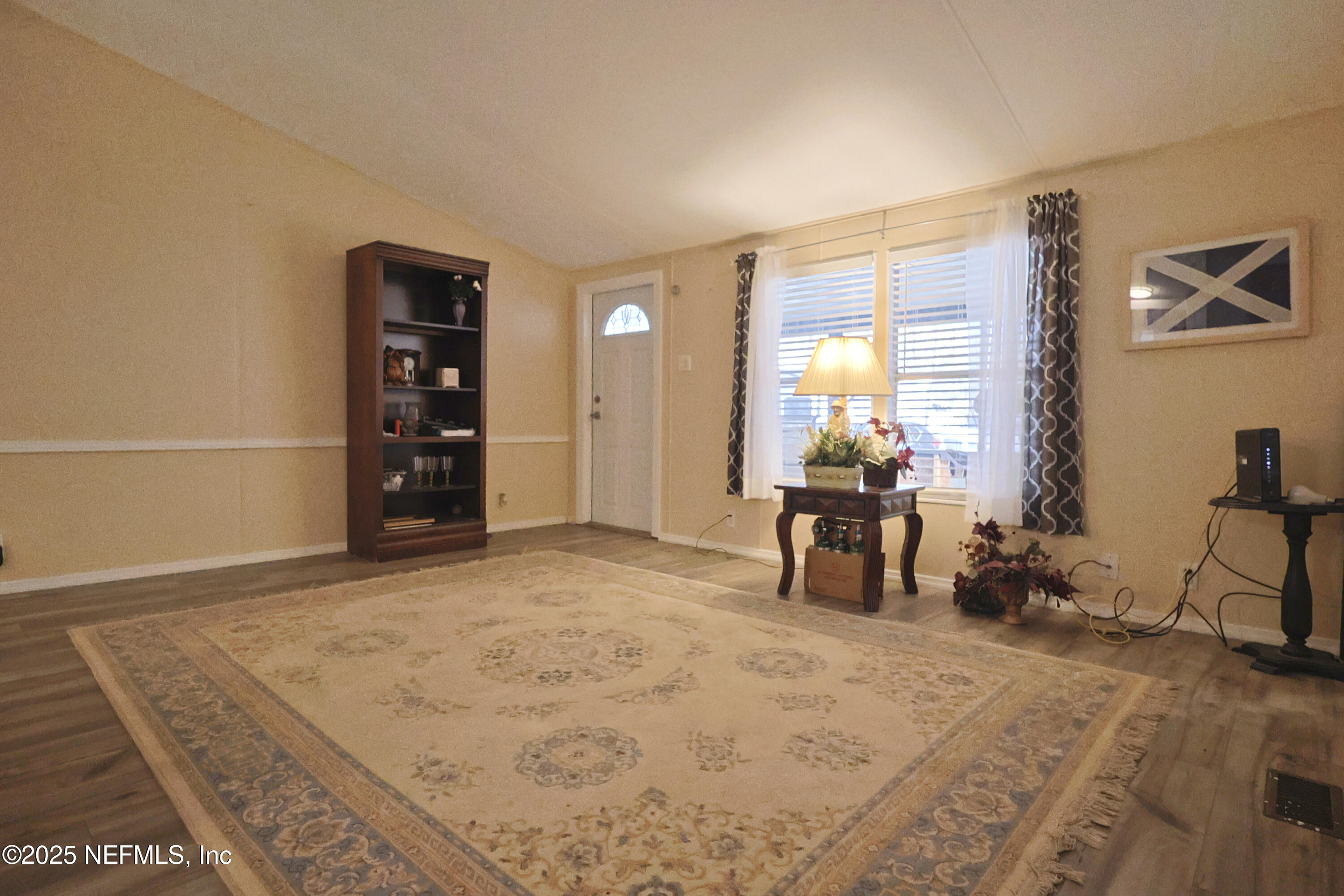 138 Edgewater Road Satsuma, FL 32189 - Photo 17 of 45 a room with furniture and a flat screen tv