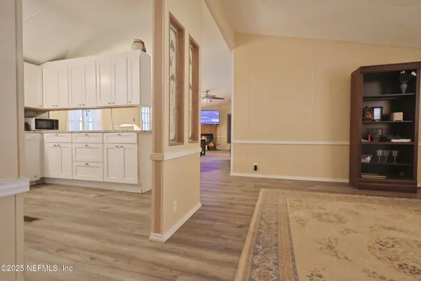a view of a kitchen with white cabinets