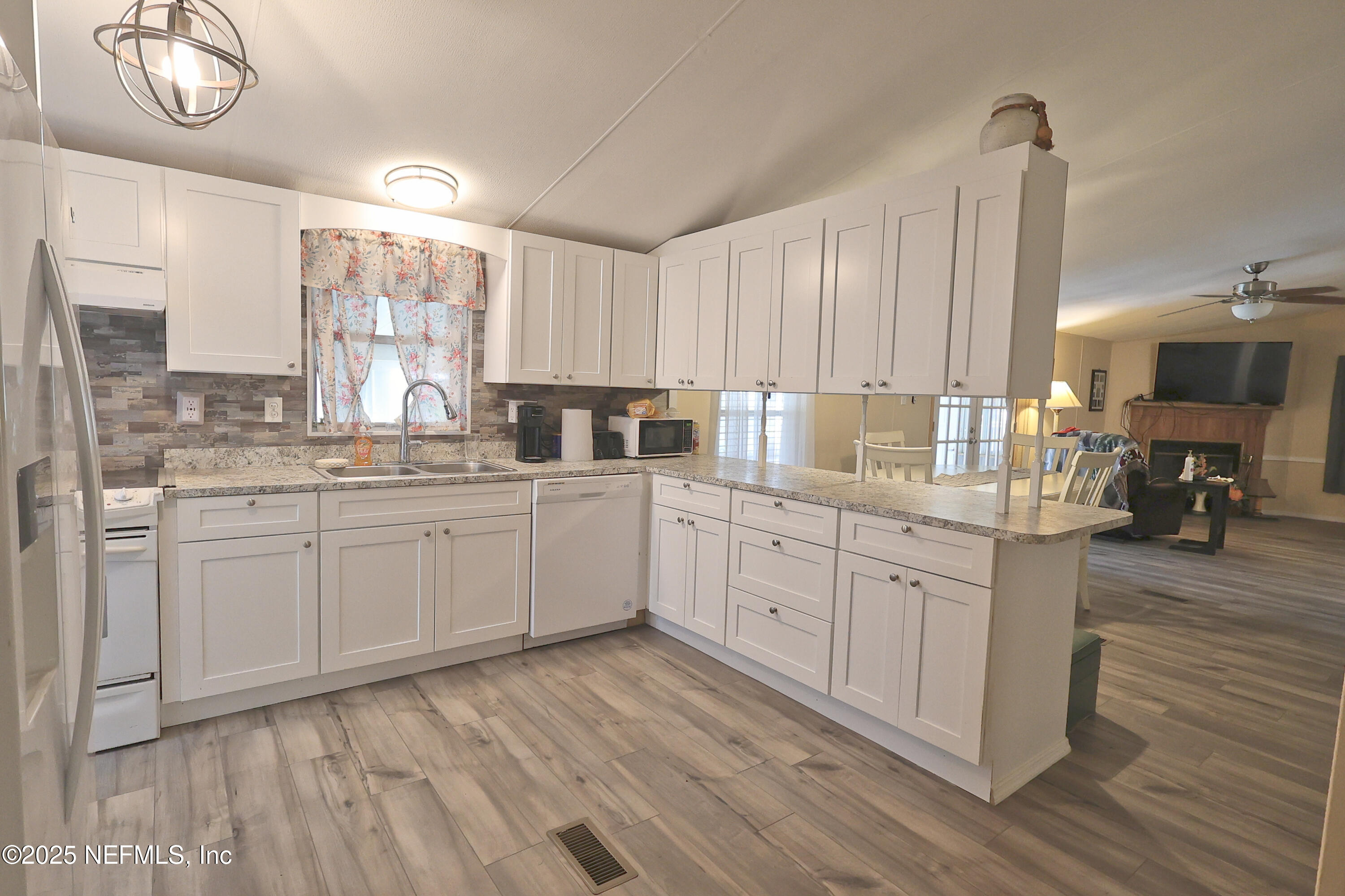138 Edgewater Road Satsuma, FL 32189 - Photo 21 of 45 a kitchen with sink cabinets and wooden floor