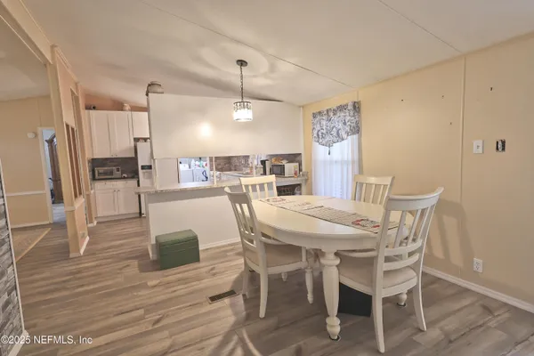 a view of a dining room with furniture and wooden floor