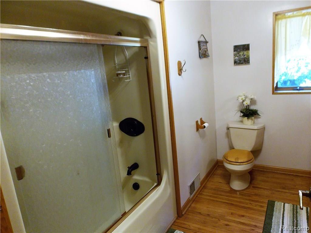 10221 Washburn Road Columbiaville, MI 48421 - Photo 13 of 37 The fixtures were recently updated in the shower of this bath. This is one of three full baths in this home.
