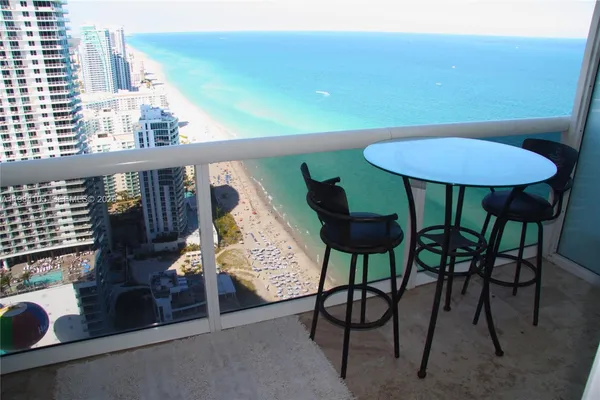a view of a chairs and table in patio