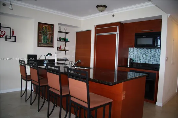 a kitchen with stainless steel appliances granite countertop furniture a sink and a refrigerator