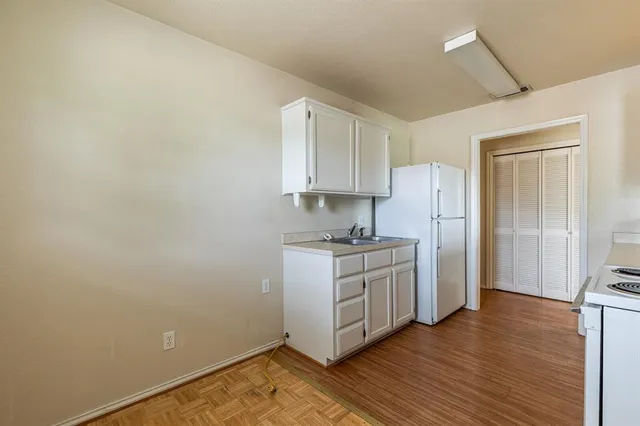 a kitchen with stainless steel appliances a sink a stove and cabinets