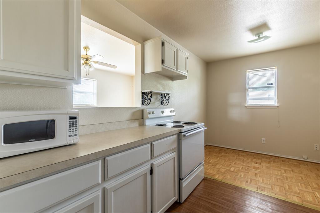 520 Live Oak Street Meridian, TX 76665 - Photo 6 of 9 a kitchen with stainless steel appliances a sink a stove and cabinets