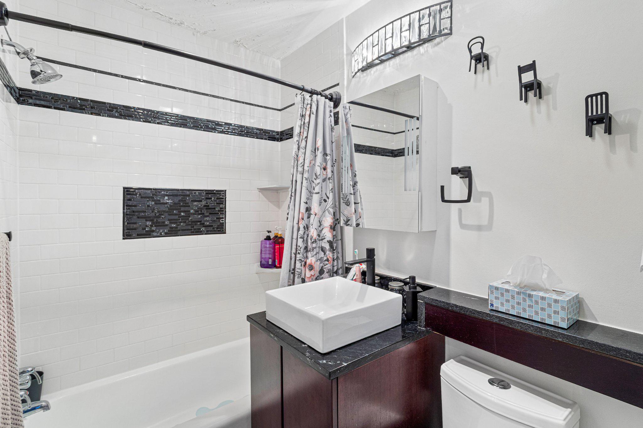 5613 Franconia Road, Unit 303 Alexandria, VA 22310 - Photo 21 of 27 a bathroom with a sink vanity granite tub shower and mirror