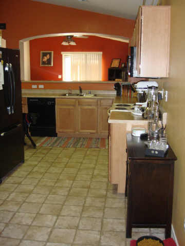 8537 West Riley Road Tolleson, AZ 85353 - Photo 6 of 9 a kitchen with a stove window and cabinets