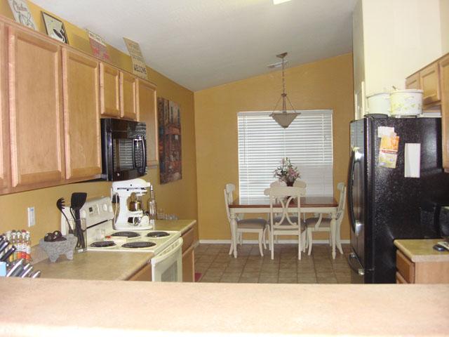 8537 West Riley Road Tolleson, AZ 85353 - Photo 9 of 9 a kitchen with a table chairs and entryway