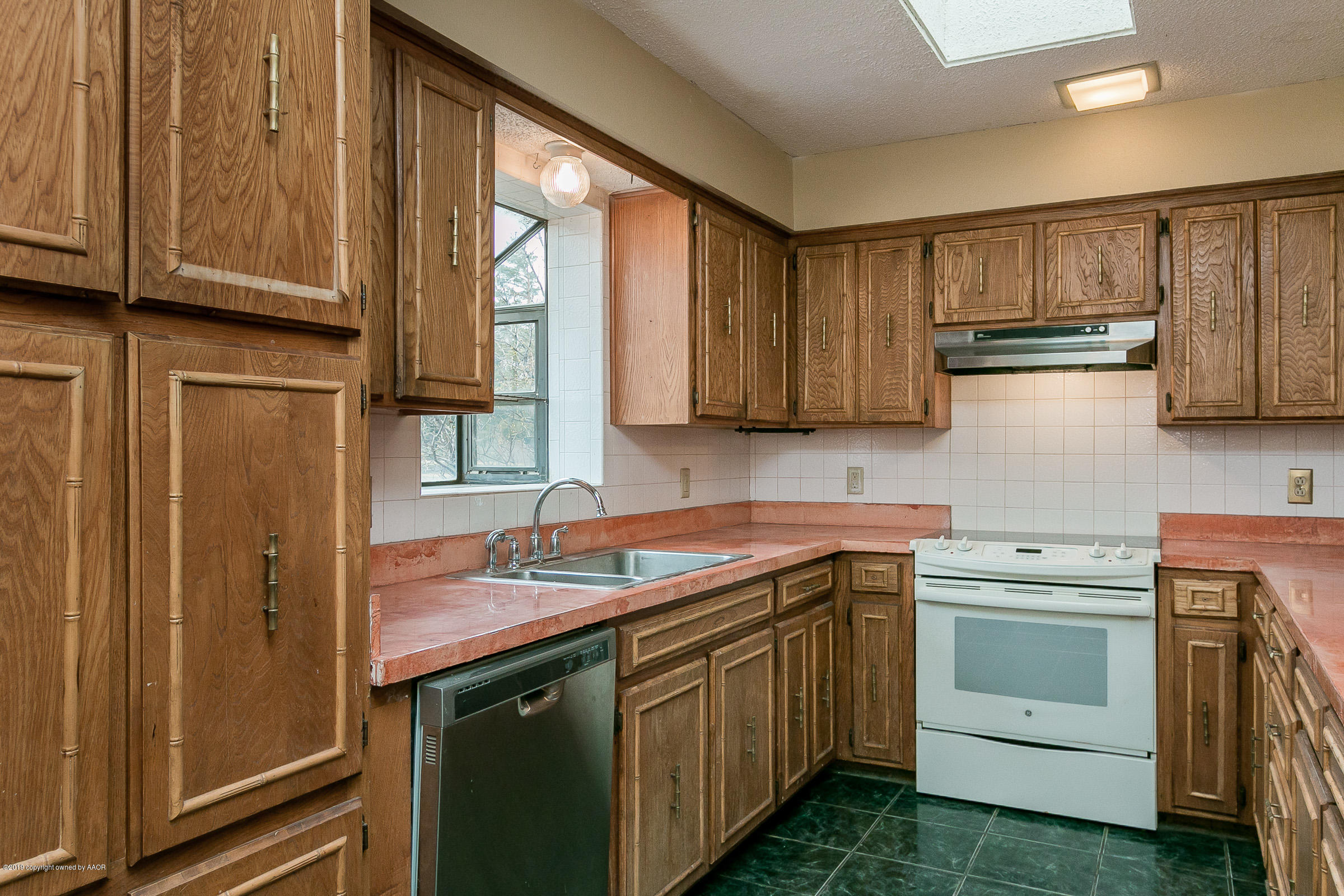 8100 Goodnight Trail Amarillo, TX 79110 - Photo 8 of 20 a kitchen with a sink stove and cabinets