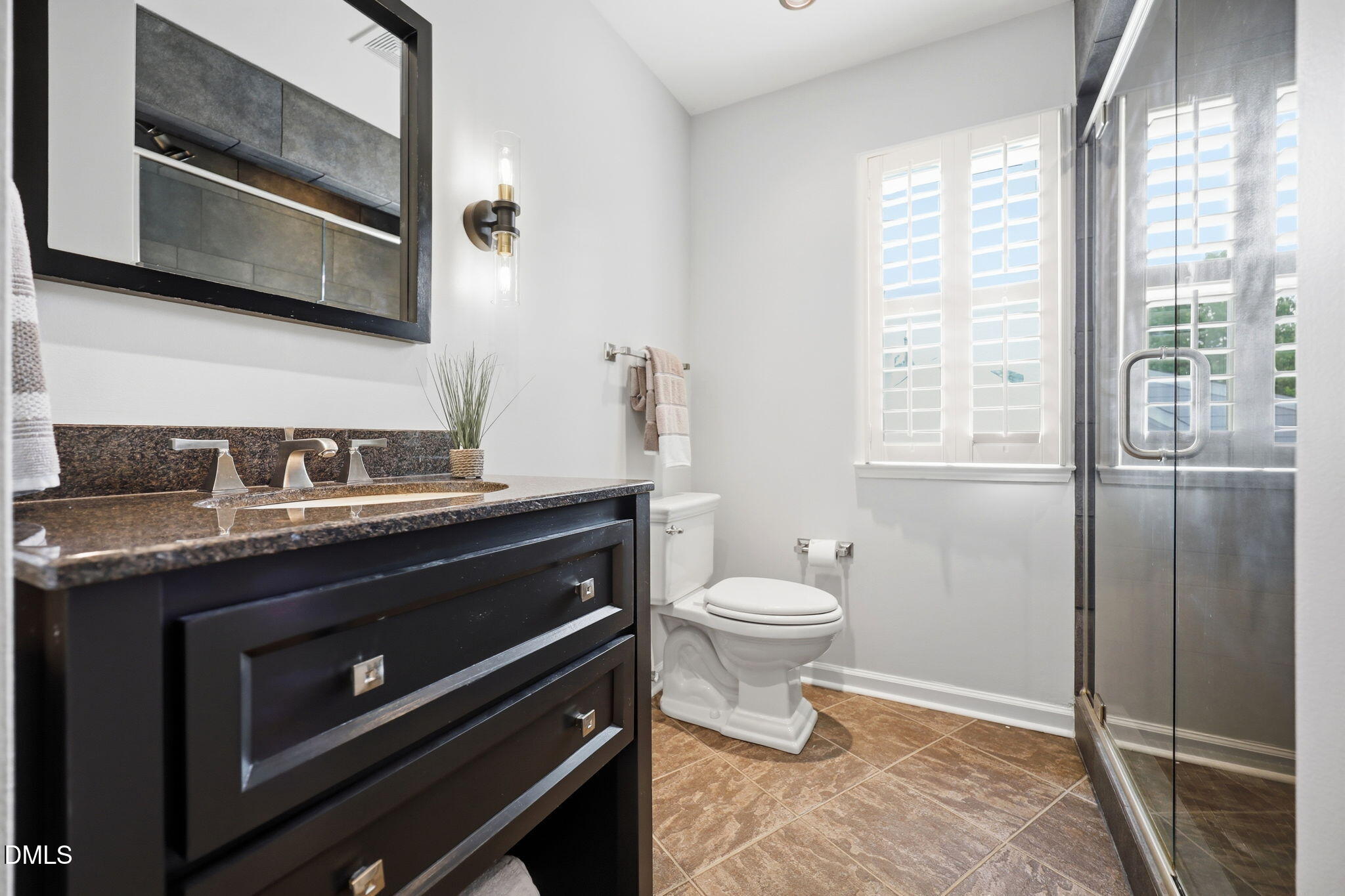 1716 Farmington Grove Drive Raleigh, NC 27614 - Photo 27 of 41 a bathroom with a toilet a sink and a window