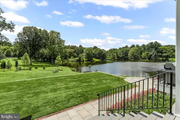 a lake view with a garden and trees