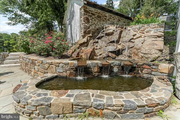 an aerial view of a house with a garden and lake view