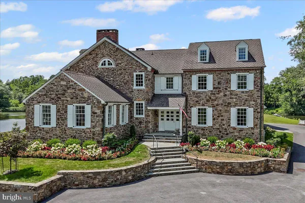 a front view of a house with a yard and potted plants