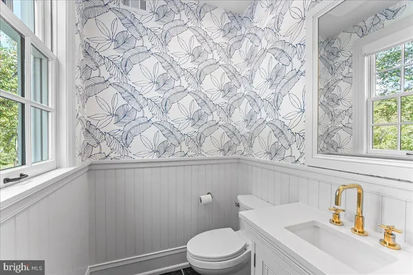 a room with stainless steel appliances kitchen island a table and chairs in it