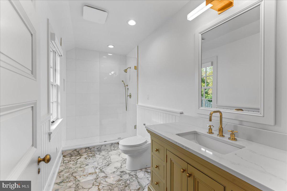 80 Heyburn Road Chadds Ford, PA 19317 - Photo 57 of 75 a bathroom with a granite countertop sink a toilet and a mirror