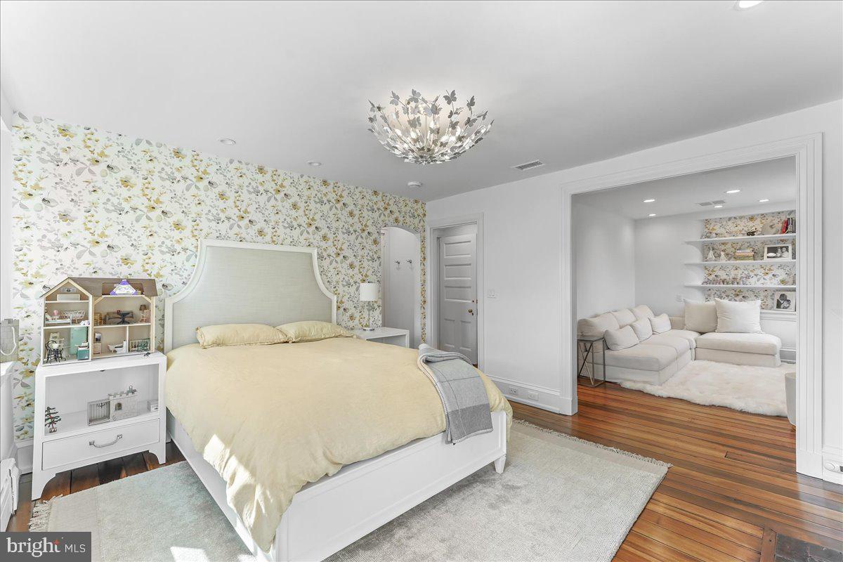 80 Heyburn Road Chadds Ford, PA 19317 - Photo 58 of 75 a bedroom with a large bed and a chandelier