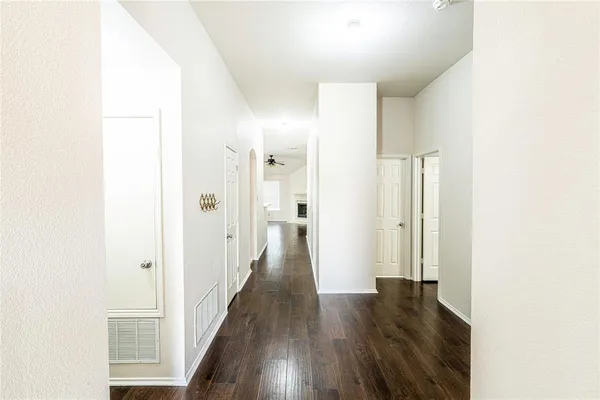 a view of a hallway with wooden floor