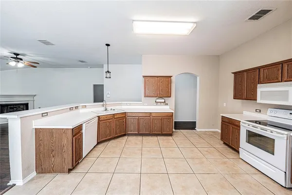 a kitchen with a stove sink and cabinets