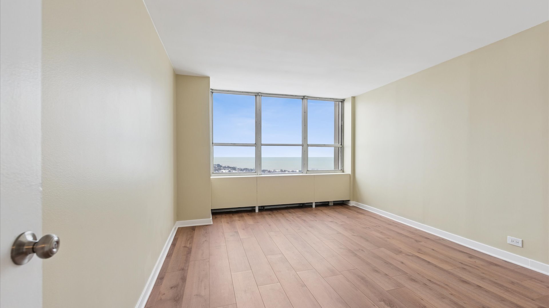 655 West Irving Park Road, Unit 3704 Chicago, IL 60613 - Photo 11 of 36 an empty room with wooden floor and windows