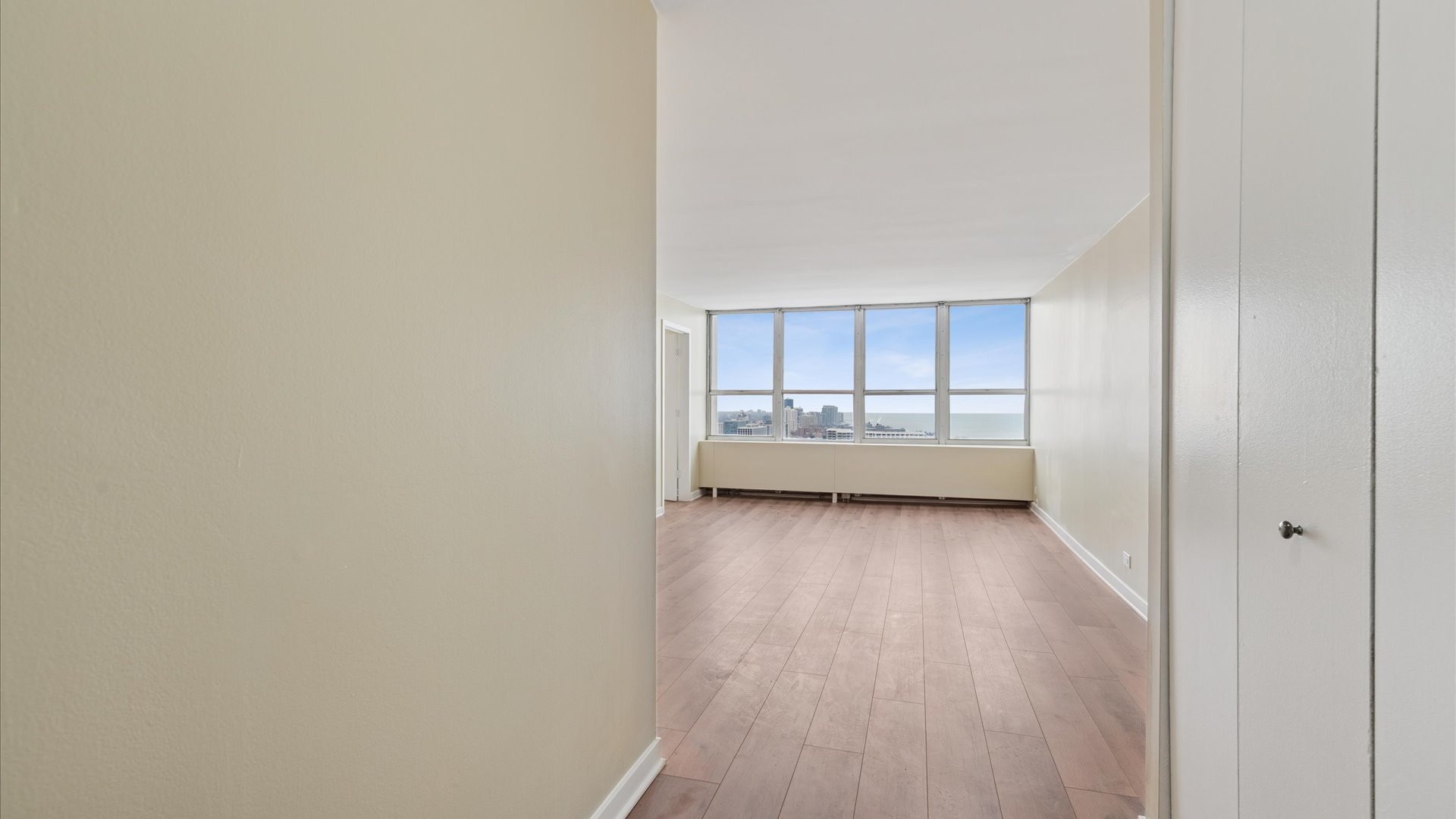 655 West Irving Park Road, Unit 3704 Chicago, IL 60613 - Photo 17 of 36 a view of a room with wooden floor and window