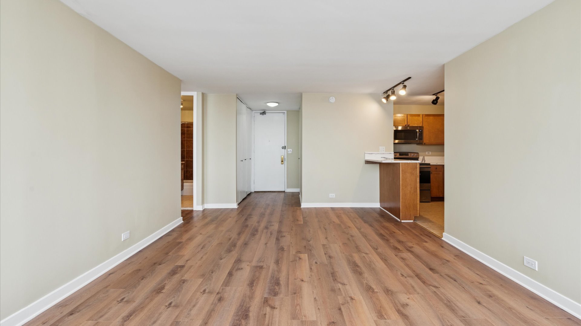 655 West Irving Park Road, Unit 3704 Chicago, IL 60613 - Photo 5 of 36 a view of empty room with wooden floor