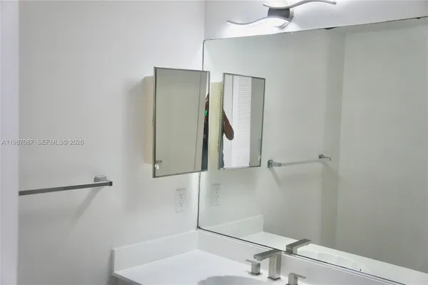 a bathroom with a sink and mirror