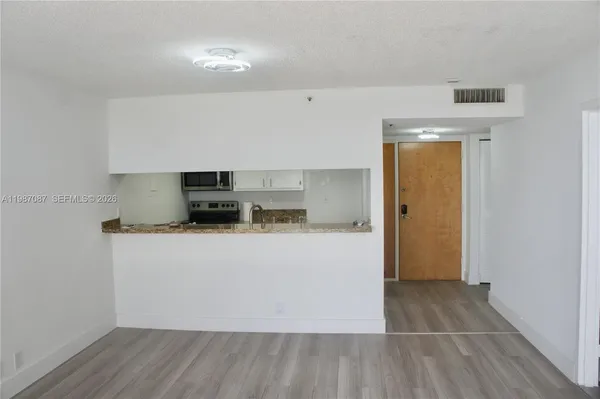 a view of kitchen with stainless steel appliances granite countertop a stove a sink and a refrigerator