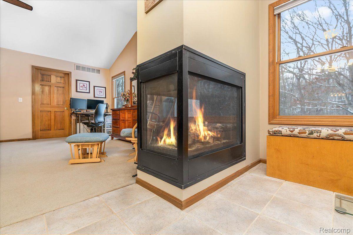 21851 Prince Road Belleville, MI 48111 - Photo 31 of 59 3-sided fireplace with window seating area