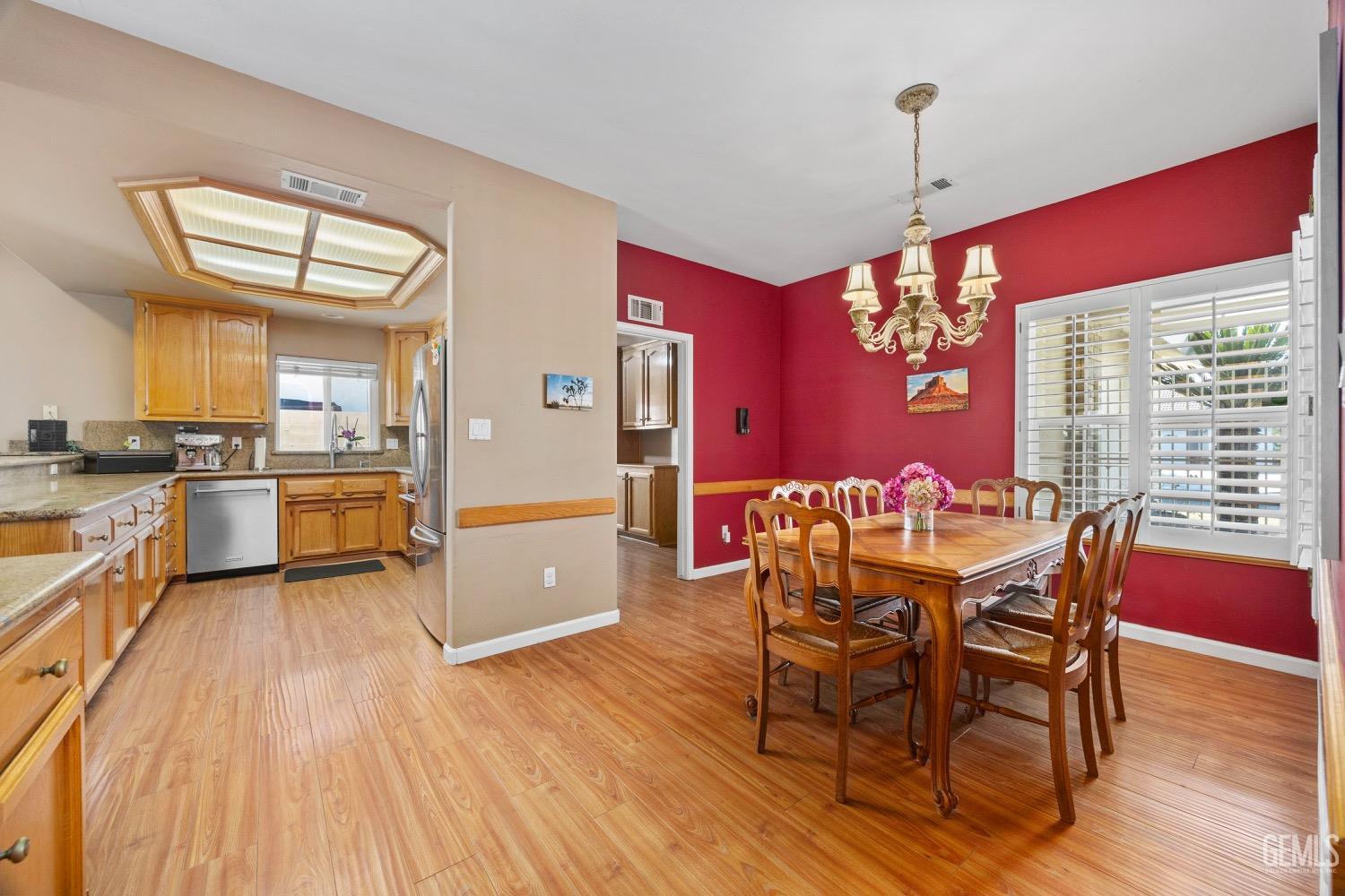 Undisclosed Address Bakersfield, CA 93314 - Photo 13 of 39 a view of a dining room with furniture and wooden floor