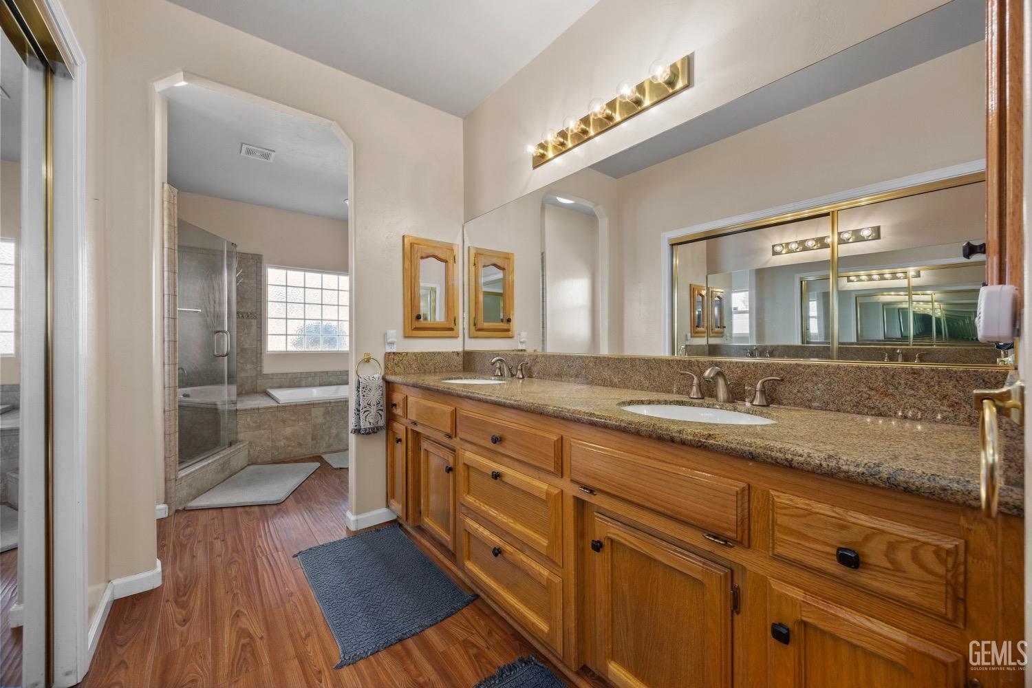 Undisclosed Address Bakersfield, CA 93314 - Photo 21 of 39 a spacious bathroom with a granite countertop sink mirror and a