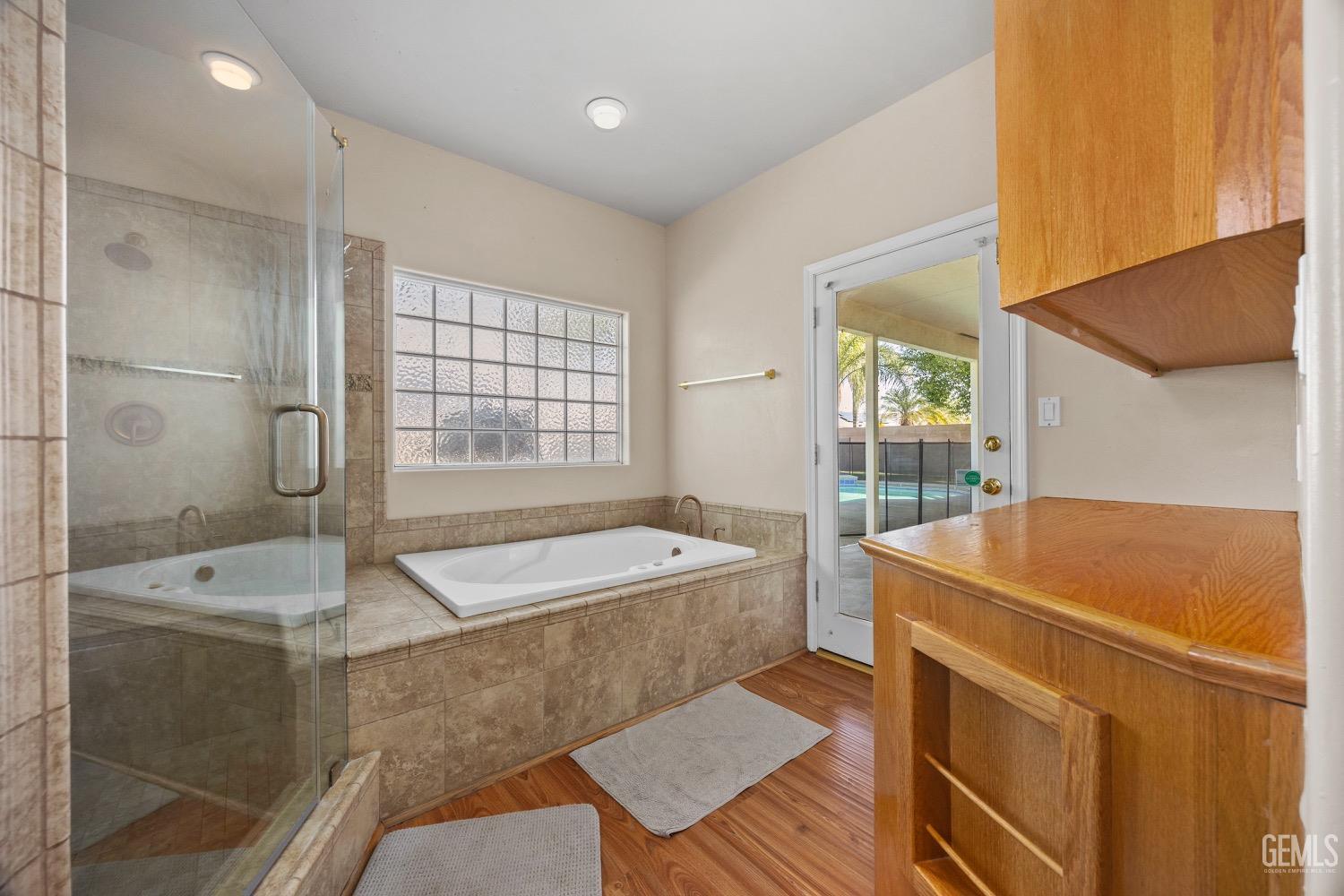 Undisclosed Address Bakersfield, CA 93314 - Photo 22 of 39 a spacious bathroom with a tub sink and mirror
