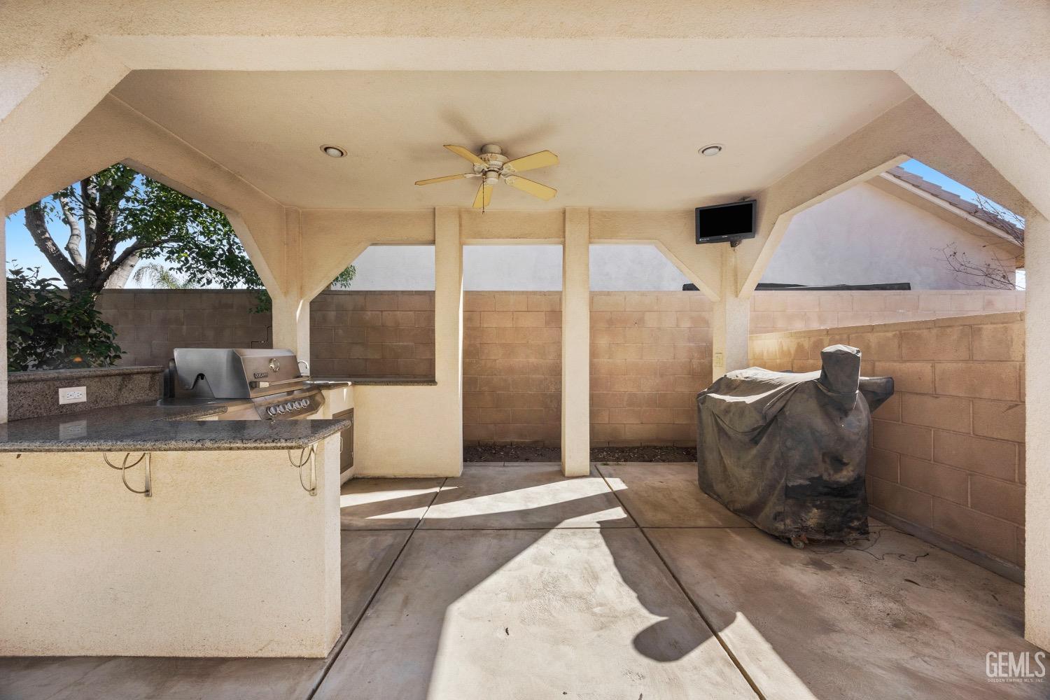 Undisclosed Address Bakersfield, CA 93314 - Photo 37 of 39 a living room with a couch and a potted plant