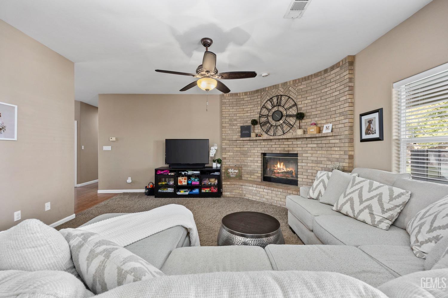 Undisclosed Address Bakersfield, CA 93314 - Photo 9 of 39 a living room with furniture a fireplace and a flat screen tv