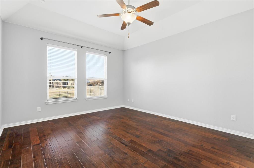 3513 Durango Root Court Fort Worth, TX 76244 - Photo 18 of 34 an empty room with wooden floor chandelier fan and windows