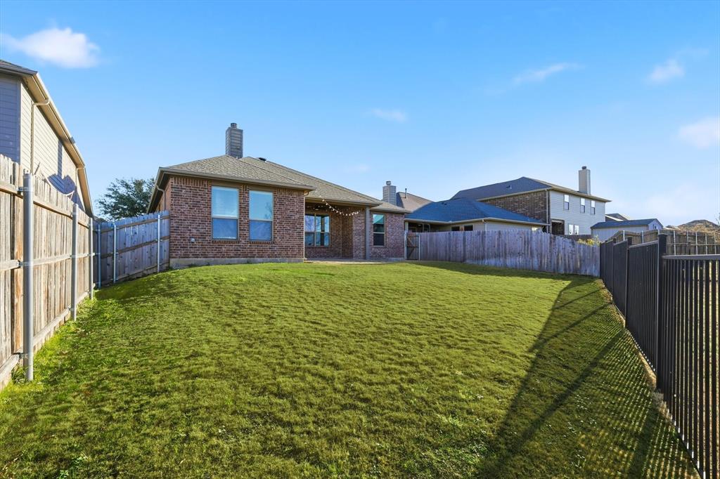 3513 Durango Root Court Fort Worth, TX 76244 - Photo 30 of 34 a front view of a house with a garden