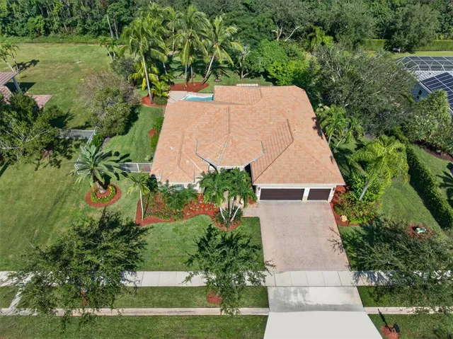 an aerial view of a house with a yard and garden